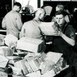Sorting Parcels Behind Counter, [ca. 1965]