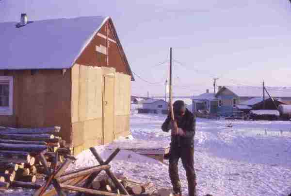 Man cutting firewood. 12/70