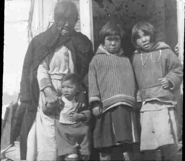 Grandmother with three Inuit children.