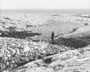 Rae standing on moraine, Marble Island., Department of Physics fonds