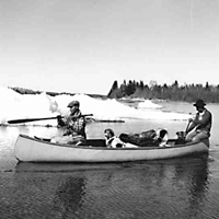 Indian Trappers in a canoe - La Ronge, SK
