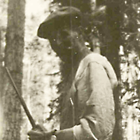 Cree Hunter Standing by Tree 